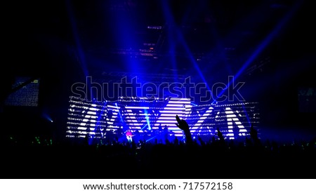 Cheering crowd at a rock concert and light show