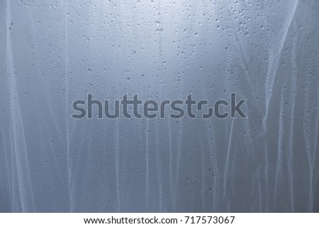water drop on shower curtain Royalty-Free Stock Photo #717573067