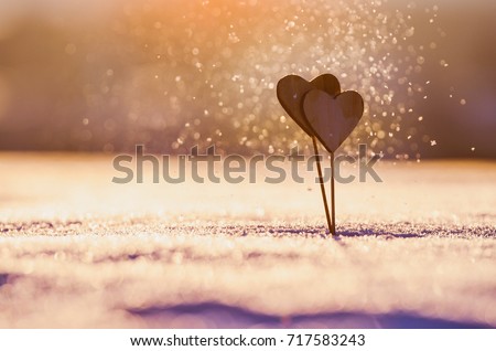 Valentine background - two wooden hearts in beautiful snowflakes in the air Royalty-Free Stock Photo #717583243