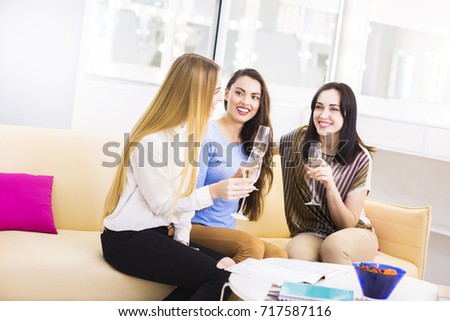 Three young girls celebrating and hafing fun with champagne