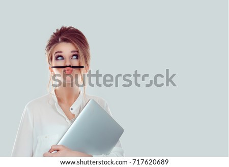 Annoyed woman, funny student with laptop computer playing holding pen between nose and lips as mustache looking up thinking playful bored after working long hours isolated light blue white background Royalty-Free Stock Photo #717620689