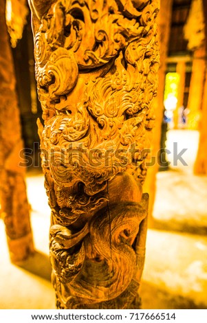 Carving art on wooden column, Thailand.