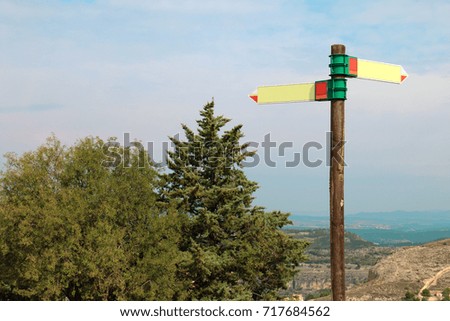 Post with blank directions  located in the forest