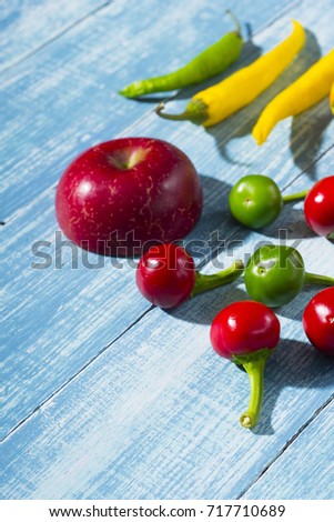autumn vegetables with shadow on worn blue wood table background