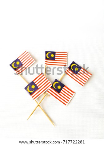 Set of toothpick with a small paper flag of Malaysia. Lined up and decorated on isolated white background.