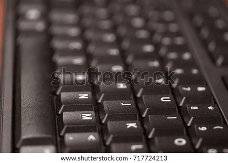 Closeup of classic QWERTY keyboard. Raised keys, with space and right of keyboard as center of picture. Great for general technology or business photos. 
