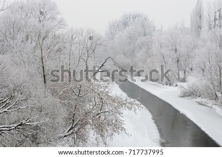 Winter landscape with frozen river, snow-covered trees, hoarfrost, white background.