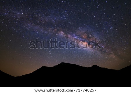 Beautiful milky way galaxy and silhouette of high moutain on a night sky before sunrise.