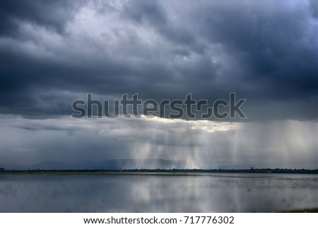 Rain cloud, raining ,little space between cloud make light pass to rain drop. Royalty-Free Stock Photo #717776302