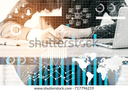 Businessman doing paperwork in modern office with business hologram. Accounting concept. Double exposure 