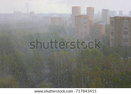 snow in spring in Moscow, landscape of city from window of multi-storey building