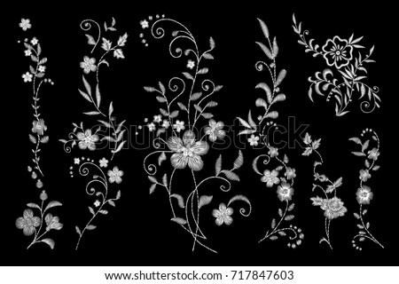 set of white lace. Traditional folk flower fashionable embroidery on the black background. A bouquet of roses and a dog rose, for printing on clothes, vector