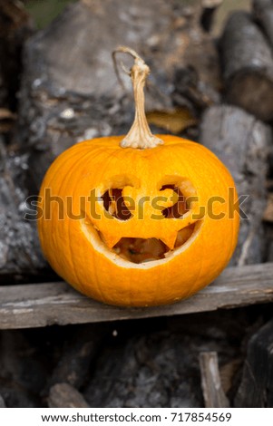 Autumn halloween jack-o-lantern on autumn wooden background