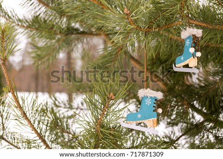 Christmas decor tree skates on the green fir branch in snow