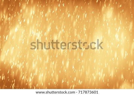 Christmas golden abstract sparkles or glitter light. Festive gold background.defocused circles bokeh or particles. New year template
