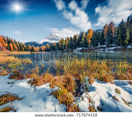 Great sunny scene on Antorno lake with Tre Cime di Lavaredo (Drei Zinnen) mount. Colorful autumn landscape in Dolomite Alps, Province of Belluno, Italy, Europe. Beauty of nature concept background.