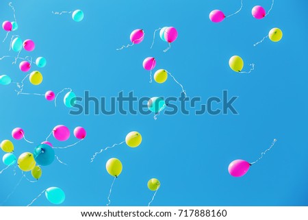 multicolored balloons in the blue sky for background