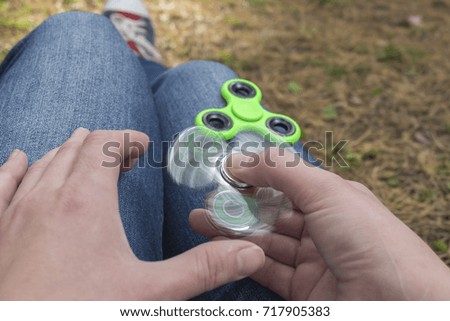 Girl playing with two Hand Spinner