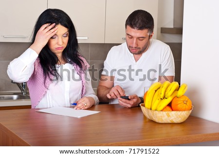 Sad couple having difficult to calculate their expenses