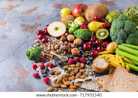 Healthy balanced dieting concept. Selection of rich fiber sources vegan food. Vegetables fruit seeds beans ingredients for cooking. Copy space background Royalty-Free Stock Photo #717931540