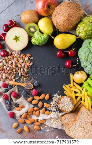 Healthy balanced dieting concept. Selection of rich fiber sources vegan food. Vegetables fruit seeds beans ingredients for cooking. Copy space background, top view flat lay