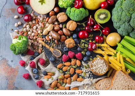 Healthy balanced dieting concept. Selection of rich fiber sources vegan food. Vegetables fruit seeds beans ingredients for cooking. Top view flat lay Royalty-Free Stock Photo #717931615