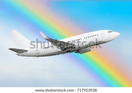Climbing airplane against a rainbow in the sky