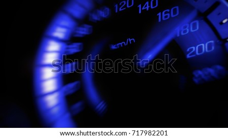 Close up and blurred mile indicator of a speed meter in a car with blue light speed at 180 Km/H in concept racing car Royalty-Free Stock Photo #717982201