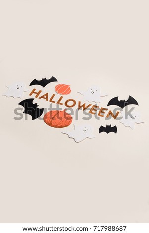 Decorated orange typeface text for halloween logo with traditional symbols handwritten on white background,
