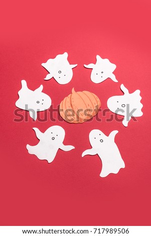 White traditional ghosts in circle with pumpkin on red background. Frame for haloween logo ant text
