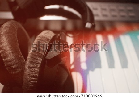 headphone on keyboard of musician with funny lighting