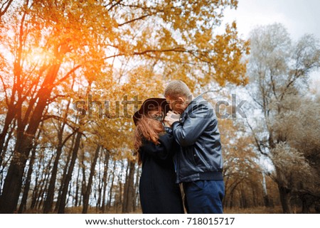 Taking a walk in the forest of a couple in love. Cute couple in an autumn forest on a picnic in the rays of a warm sun