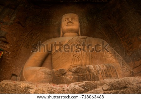 The Buddha statue in Leshan, China. The image of a man sitting in a lotus pose in a rock