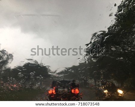 Rain splatters car windshield during storm caused difficult driving conditions