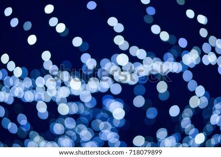 Holiday picture. Blurred texture of bright New Year lights on a dark blue background. Beautiful light christmas garland. Bright abstract background ideal for any design 