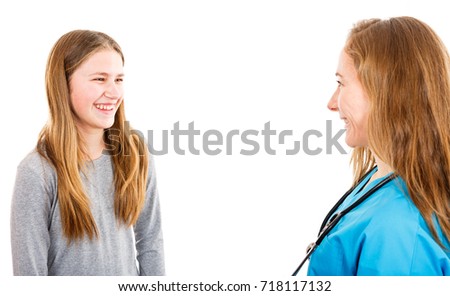 Photo of smiling young girl and pediatrician