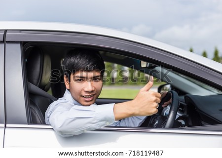 Young asian businessman sitting in the modern car. For car rent or car business concept