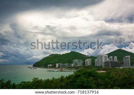 Panorama of the bay - sea, beach, buildings and palm trees. Dadonghai bay, Sanya, Hainan, China.