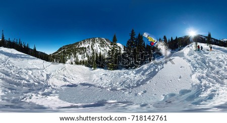 Snowboarder freerider jumping from snow ramp. Spherical 360 vr180 panorama. Royalty-Free Stock Photo #718142761