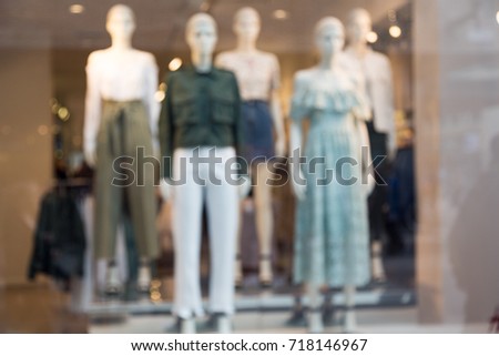  Blur women's fashion store background. Blurred picture of female mannequins standing in a shop window display.