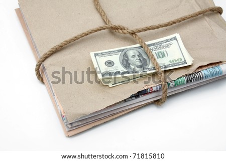 newspaper stack and dollars