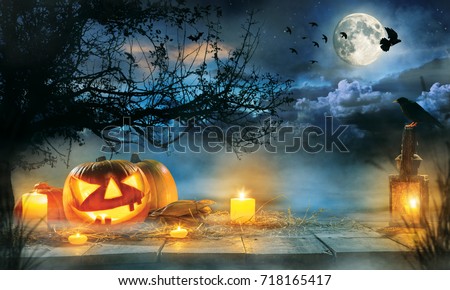 Spooky halloween pumpkins on wooden planks with dark horror background. Celebration theme, copyspace for text.