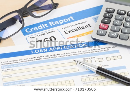 Loan application form excellent credit score with calculator, glasses, and pen