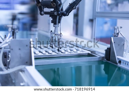 robot with vacuum suckers picks the item from the conveyor in manufacture factory