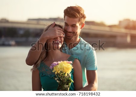 Young boyfriend is giving beautiful bouquet of flowers to his girlfriend.Man giving flowers to a woman
Image is intentionally toned.