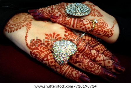 Bride- beautiful muslim bride hands with henna and ring (mehndi hands)