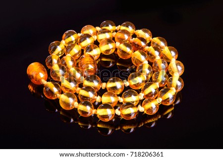 amber beads round fashion accessory decoration on black background