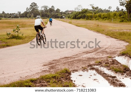 Cyclist in motion on the public outdoor park.Sport man ride on a bicycle.Outdoor exercise concept.