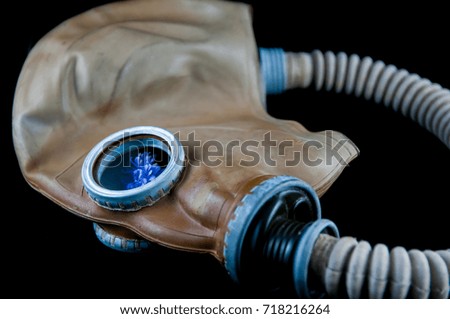 Blue flower in the gas mask, focus on the glass.