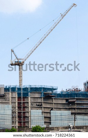 crane and construction building with blue sky background